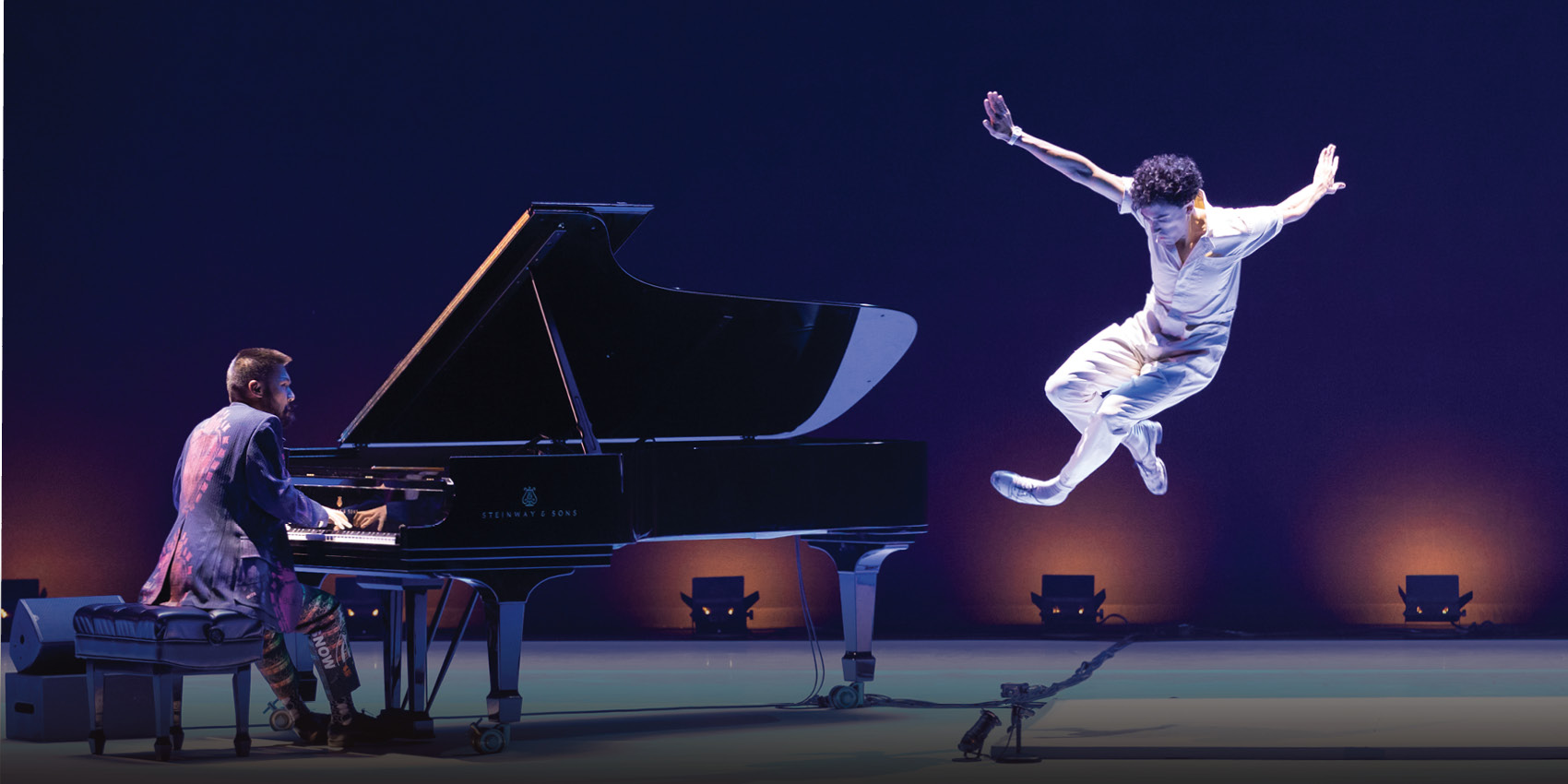 Conrad Tao at the piano as Caleb Teicher performs a tap dance leap