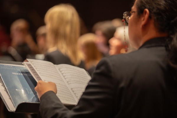 UW choral singers rehearsing with sheet music