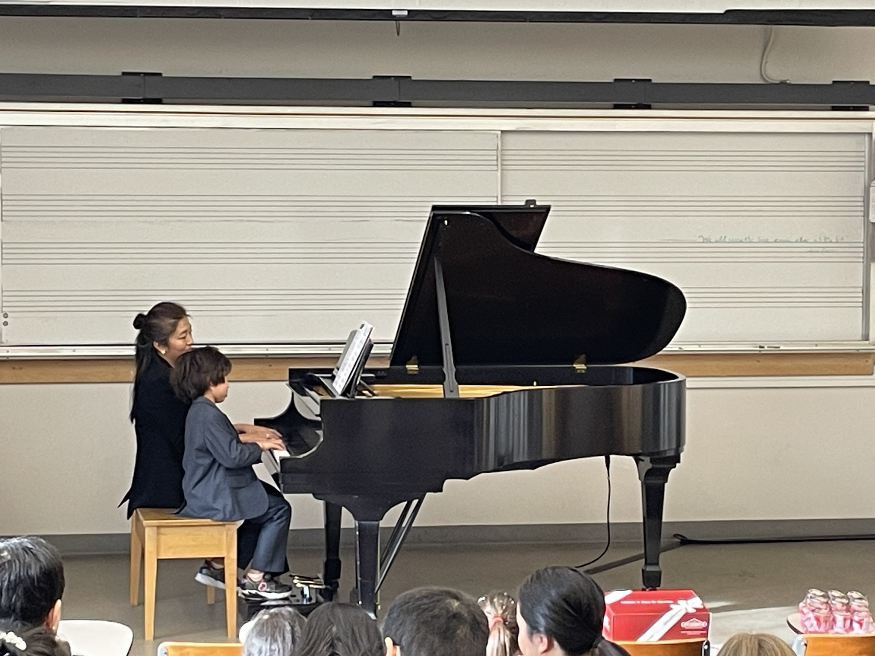 Chiao-Yu Wu performing a piano duet with a student at the Winter Studio Recital