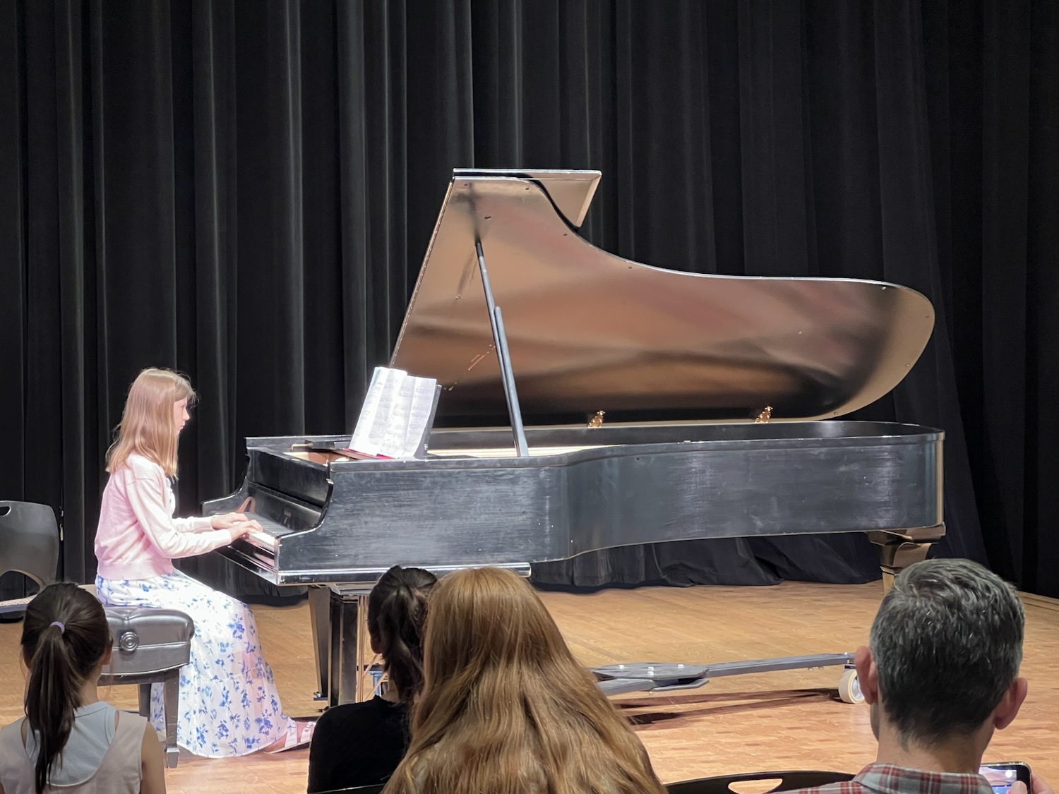 A student performing solo for the recital audience