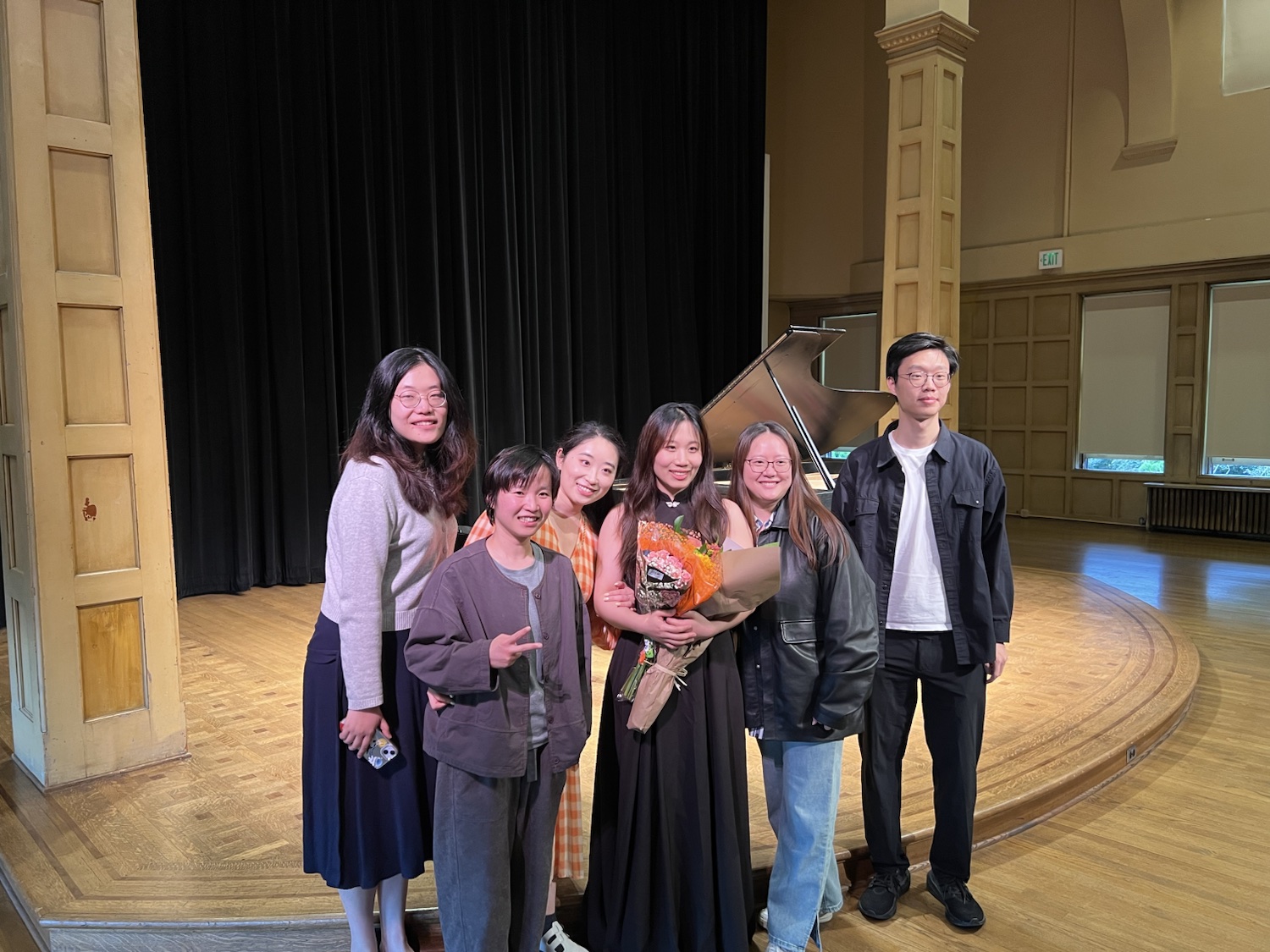 Students celebrating together with flowers after the recital