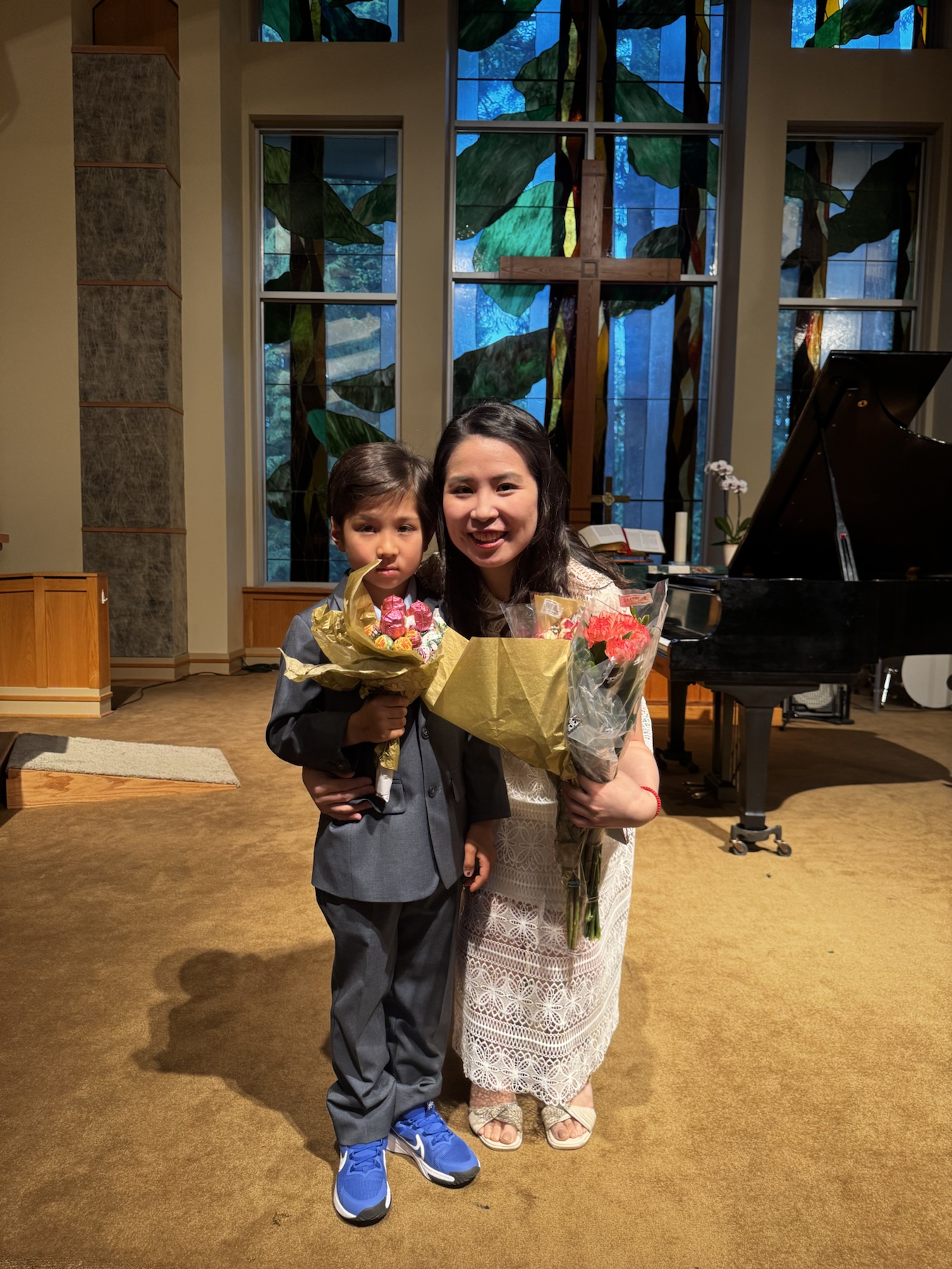 Chiao-Yu Wu and a student holding flowers after the Spring Studio Recital